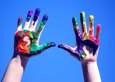 a child's hands with painted designs on them