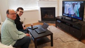 picture of Peter and Ben Hartmans worshiping at home with Bloor Street United on Palm Sunday.