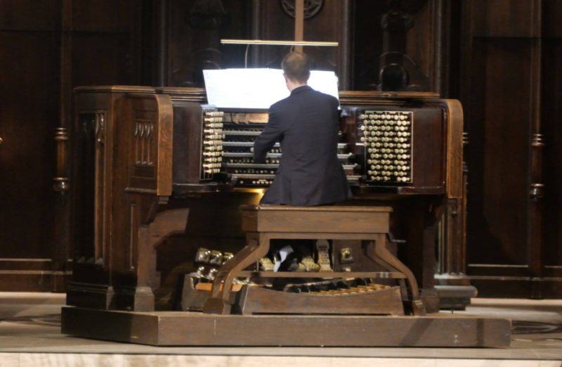 Musician playing the organ in a church