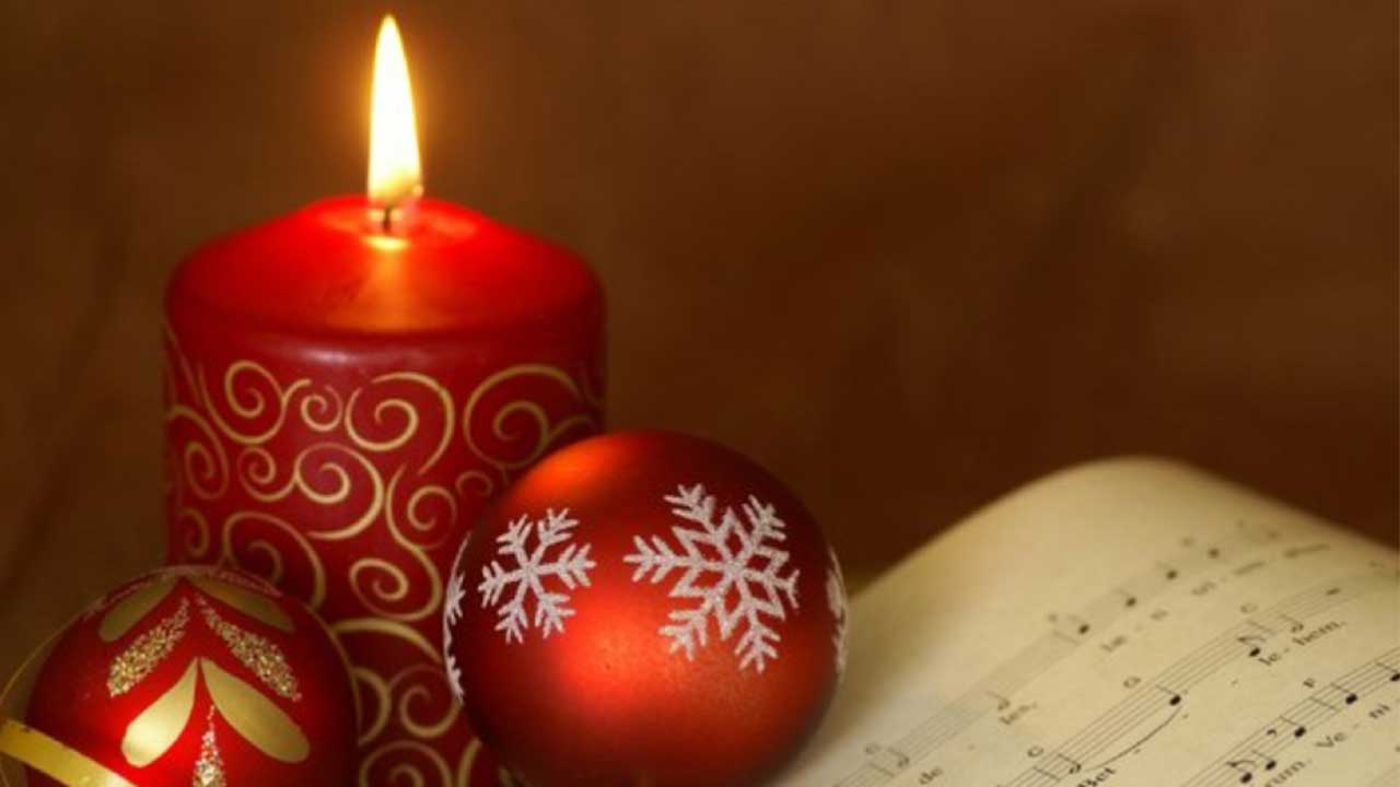 red ornaments, candle with sheet music