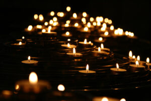 lit tealight candles in darkness