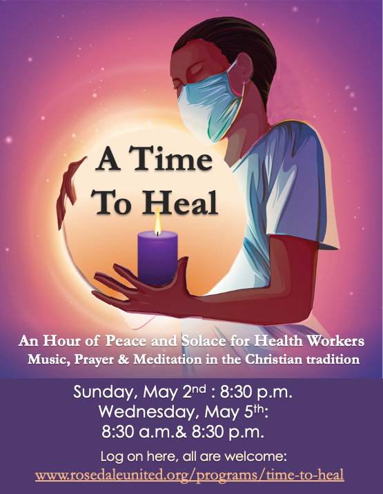 a healthcare worker in a mask, holding a candle