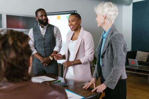 image of people standing around a table talking